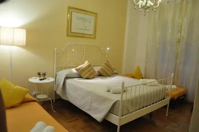 a bedroom with a white bed and a chandelier at Big Home In Vatican in Rome