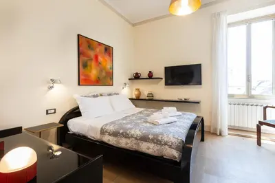 a bedroom with a bed and a tv on the wall at Casa Prati by Rental in Rome in Rome
