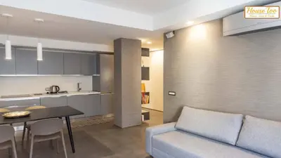 a living room and kitchen with a couch and a table at House - Via Boccea - Too in Rome