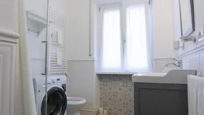 a bathroom with a washing machine and a sink at Armonia Mediterranea Apartments in Rome