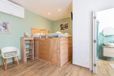 a bedroom with a bed on top of a wooden dresser at Vatican Cozy Studio in Rome