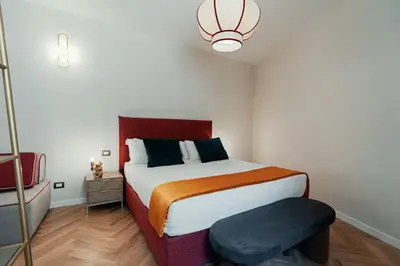 a bedroom with a bed and a stool in it at Casa mia Navona Rooms in Rome