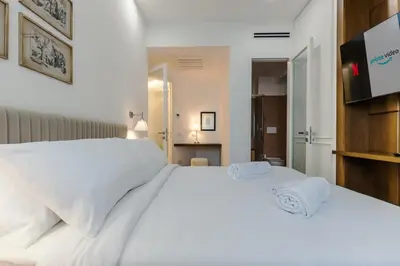 a bedroom with a white bed with towels on it at Chigi Home in Rome