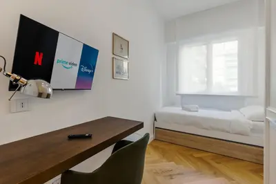 a bedroom with a bed and a table and a desk at Chigi Home in Rome