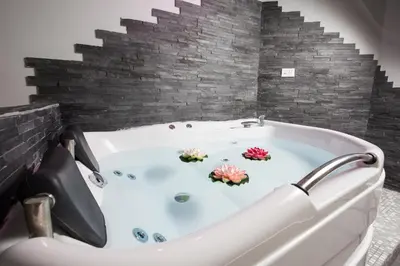 a bath tub with flowers in the middle of a bathroom at Royal House Vaticano in Rome