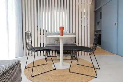 a table with chairs and a vase on it in a room at Caracalla Charming Terrace Loft in Rome