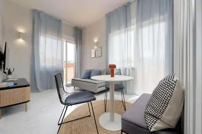 a living room with a table and chairs and a couch at Caracalla Charming Terrace Loft in Rome
