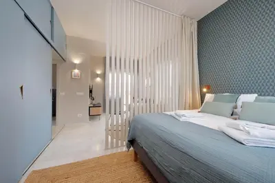 a bedroom with a large bed and a hallway at Caracalla Charming Terrace Loft in Rome