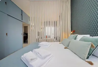 a bedroom with a large white bed with towels on it at Caracalla Charming Terrace Loft in Rome