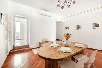 a dining room with a wooden table and chairs at Leonina Art Loft in Rome