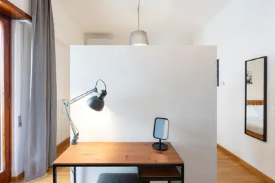 an office with a desk with a lamp on it at Hill Houses - art & stay - Rome in Rome