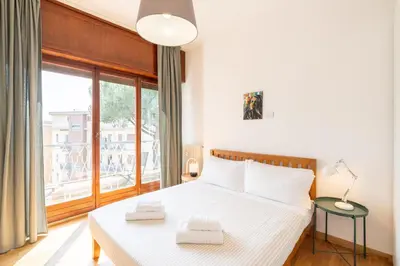 a bedroom with a bed and a large window at Hill Houses - art & stay - Rome in Rome