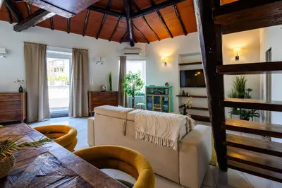 a living room with a couch and a table at Maria Luxury Apartment with City View Terrace in Rome