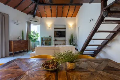 a living room with a couch and a table at Maria Luxury Apartment with City View Terrace in Rome