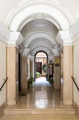 an ornate hallway in a building with a ceiling at Maria Luxury Apartment with City View Terrace in Rome