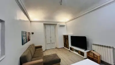 a living room with a couch and a flat screen tv at My house in Rome