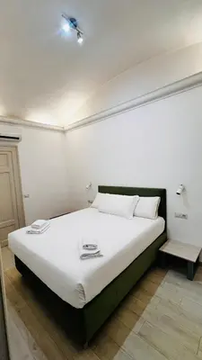 a bedroom with a large white bed in a room at My house in Rome