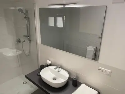 a white bathroom with a sink and a shower at Casa Bonosa in the Heart of Rome CISE 25369 in Rome