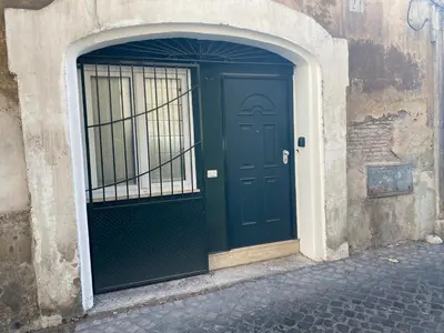 a green door in a building with a gate at Casa Bonosa in the Heart of Rome CISE 25369 in Rome