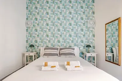 a bedroom with a bed with two side tables at TrastEva nel cuore di Trastevere a San Cosimato in Rome