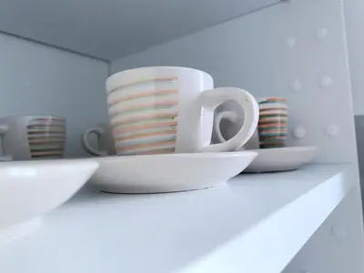 a group of cups and bowls on a shelf at TrastEva nel cuore di Trastevere a San Cosimato in Rome