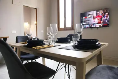 a dining room table with chairs and wine glasses at Rome, very central 2 bedrooms 4 beds in Rome