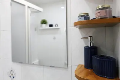 a bathroom with a shelf with a soap dispenser and a mirror at Rome, very central 2 bedrooms 4 beds in Rome