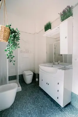 a bathroom with a white sink and a toilet at Marilyn Rooms in Rome