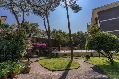 a garden with chairs and trees and a building at VaticanRhome I in Rome