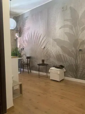 a room with a wall with a mural of plants at ZAIRA ROMA HOUSE, alloggio per uso turistico in Rome