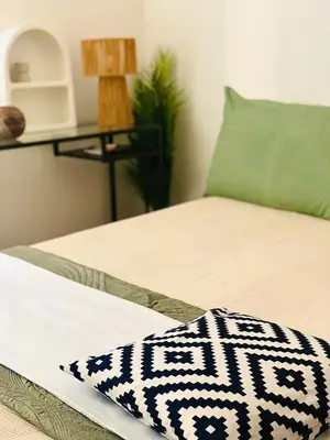 a bed with a black and white blanket on it at ZAIRA ROMA HOUSE, alloggio per uso turistico in Rome