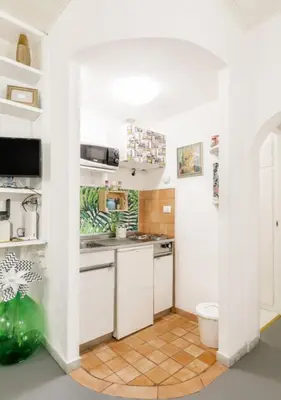 a white kitchen with a sink and a toilet at RHOMENJOY Pied-à-terre Colosseo in Rome