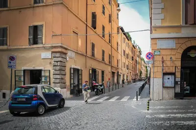 a small car parked on a city street at RHOMENJOY Pied-à-terre Colosseo in Rome