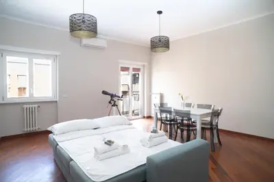 a living room with a bed and a dining room at Stile e spazio nel cuore di Roma in Rome