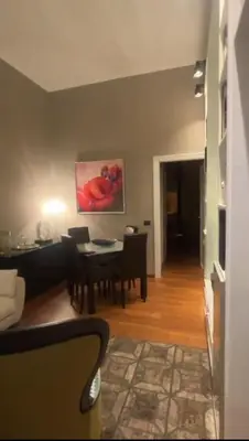 a living room with a table and a dining room at La Dimora del Brancaccio in Rome