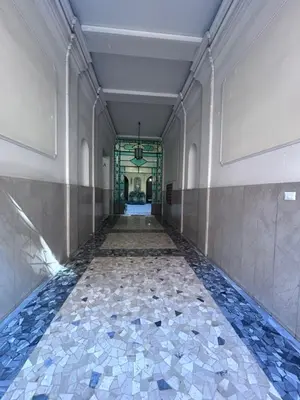 a hallway with a tile floor in a building at La Dimora del Brancaccio in Rome