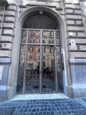 a door with an iron gate on a building at La Dimora del Brancaccio in Rome