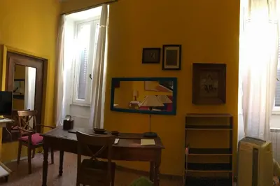 a dining room with a table and a mirror on the wall at Appartamento del Boschetto in Rome