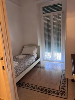 a small bedroom with a bed and a window at Hanna's House Metro Pyramid in Rome