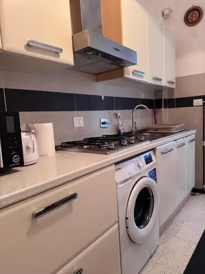 a kitchen with a stove and a washing machine at Hanna's House Metro Pyramid in Rome