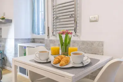 a table with two cups of coffee and croissants at Open Space Moderno a 20 Minuti dal Colosseo vicino alla Metro A e C in Rome