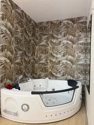 a white bath tub in a room with a wall at Gianvenuti House Rome - Metro A with Jacuzzi in Rome