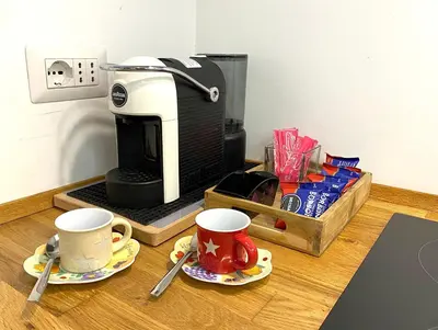 a table with two cups and a coffee maker at Karma Trastevere Loft in Rome
