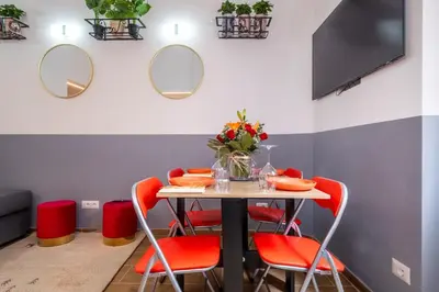 a dining room with a table and red chairs at ht vittorio in Rome