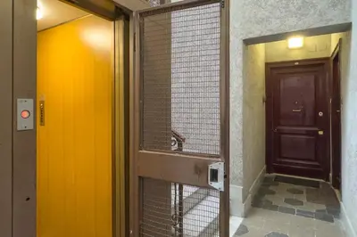 a bathroom with a mirror and a door with a fence at ht vittorio in Rome