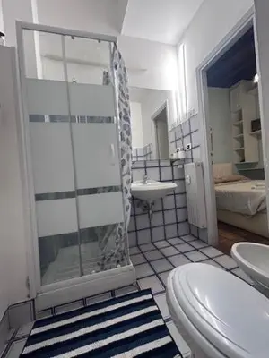 a bathroom with a shower and a toilet and a sink at The Father s House in Rome