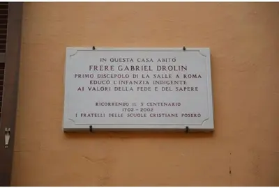 a sign on the side of a building at The Father s House in Rome