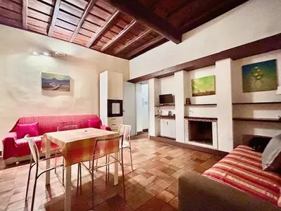 a living room with a red couch and a table at The Father s House in Rome