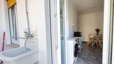 a bathroom with a sink and a washing machine at Rosina's House in Rome