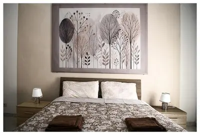 a bedroom with a bed with two lamps and a painting at Raffa al Pigneto in Rome